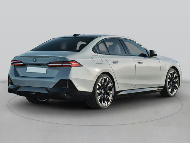 A silver 2025 BMW i5 sedan shown from the rear, featuring sleek lines and sporty wheels.