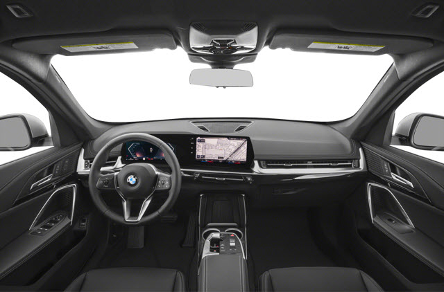 The interior of a 2026 BMW X1 showing a steering wheel, dashboard, and touchscreen display.