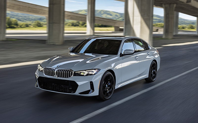 BMW 330i xDrive motion shot driving down the road.